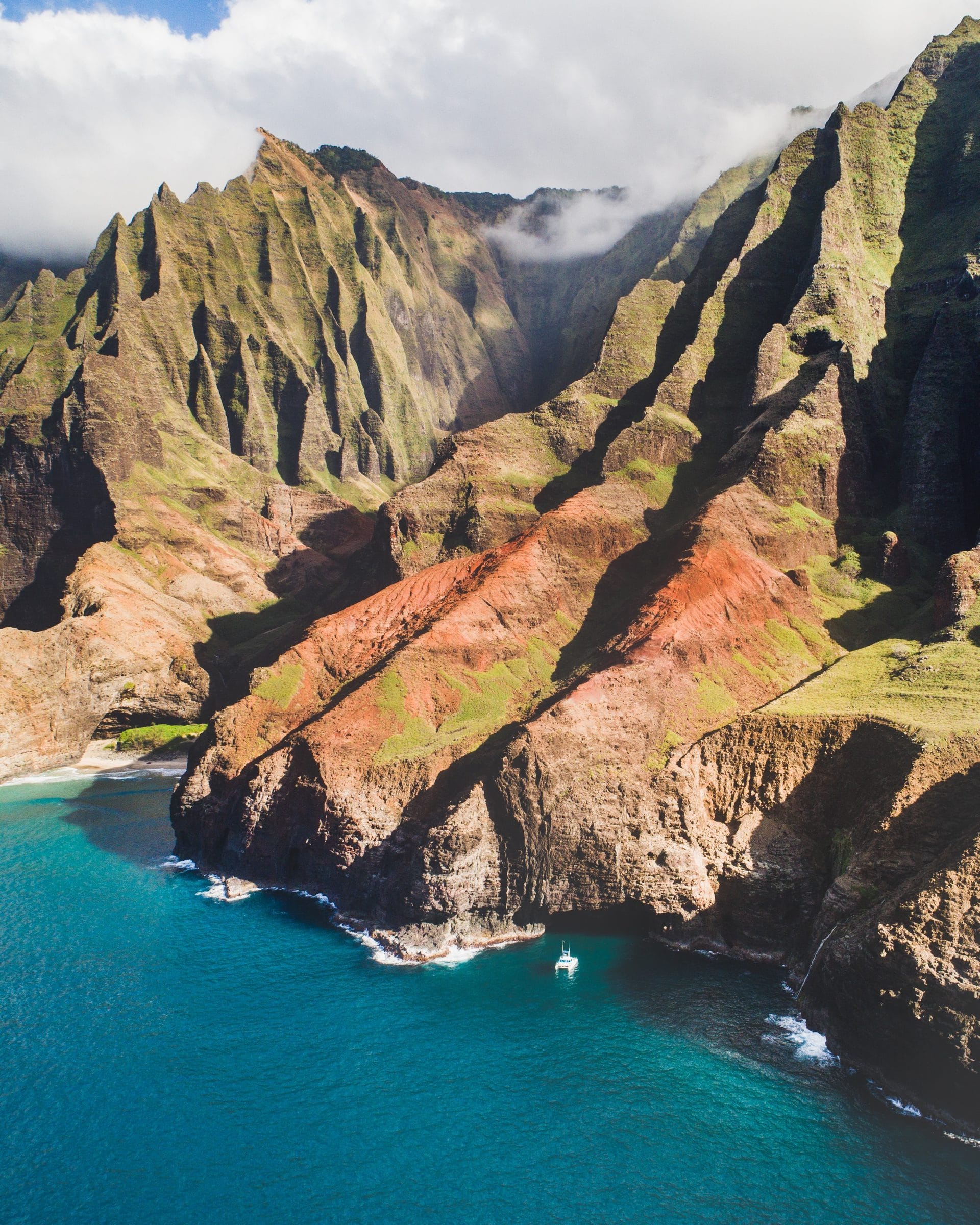 Aerial of sea cliffs and a turquoise cove