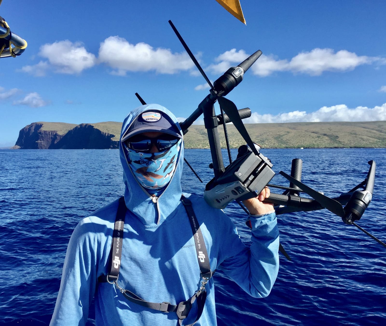 Jordan holding a drone on a boat
